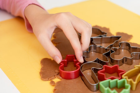 Selective focus. Making gingerbread cookies with various Christmas cookie cutters. Gingerbread dough. Family fun Christmas momentsの写真素材