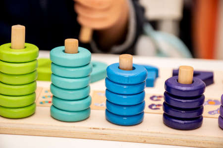 Baby toddler early development. Wooden stack and count rainbow colored learning game. Child learn colors and numbersの写真素材