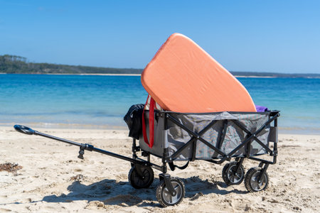 Outdoor beach cart wagon on a sandy beach near the ocean. Family vacation holidays mock up conceptの写真素材