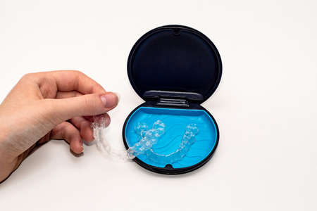 Transparent aligners and storage case box. Invisible braces. Clear teeth straighteners. Plastic bracersの写真素材