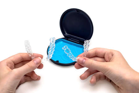 Transparent aligners and storage case box. Invisible braces. Clear teeth straighteners. Plastic bracersの写真素材