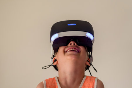 A boy wearing VR headset glasses. Virtual reality simulator technology. Gamingの写真素材