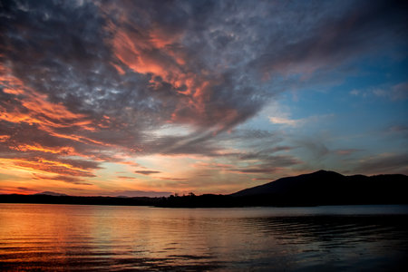 Beautiful sunset on tranquility lake. Water reflections nature backgroundの写真素材
