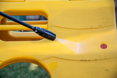 Cleaning washing kids cubby playhouse on the backyard with high pressure washer cleaner. Spring...