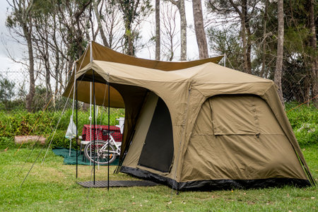 Family tent setup at the campsite surrounding by nature in caravan holiday park. Camping vacationの写真素材
