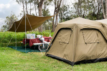 Family tent setup at the campsite surrounding by nature in caravan holiday park. Camping vacationの写真素材