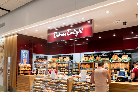 Sydney, Australia 01-04-2022: Exterior view of Bakers Delight bakery - a part of large Australian-owned bakery franchise chain with over 700 local outlets. Customer buying bread at local bakery.のeditorial素材