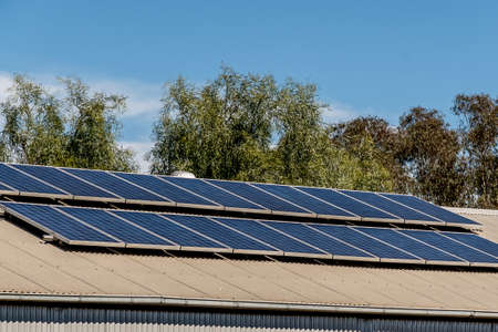 Solar panels on the roof of industrial building warehouse. Renewable solar energy conceptの写真素材