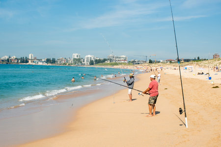 Sydney, Australia 2020-06-07 People fishing on a sandy beach near the ocean on Greenhills beach, Cronulla NSW.のeditorial素材