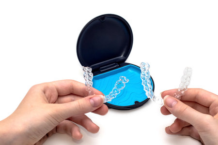 Transparent aligners and storage case box. Invisible braces. Clear teeth straighteners. Plastic bracersの写真素材