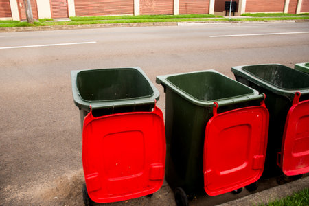Australian garbage wheelie bins with colorful lids for general and recycling household waste on the street kerbside for council rubbish collectionの写真素材