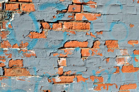 Old brick wall with graffiti. Painted Distressed Wall Surface. Vintage Red Brick Wall With Sprinkled Plasterの写真素材