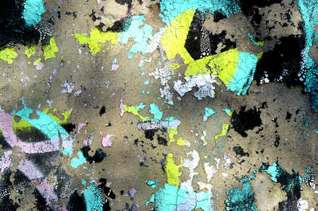Abstract photo background. Old graffiti paint on the wall. Fragment with scratches and cracks....