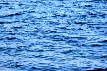 Blue ocean water, photo background. Beautiful summer sea. Ocean surface natural background.の写真素材