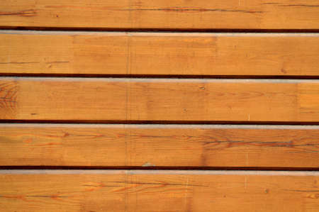 Brown wood plank wall. Old and beautiful background. Natural pattern for design. Grunge background. Peeling paint on an old wooden wall. Rustic style wallpaper. Timber texture.の写真素材
