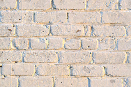 Old white brick wall. Ancient stone texture background. Urban background, white ruined industrial brick wall with copy space. Home and office design backdrop. Vintage effect.の写真素材