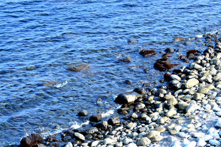 Beautiful romantic photo, seashore on the beach. Relaxing seascape. Waves with foam on the sea. Summer sunny day. Vacation spirit. Beautiful landscape. Nature background.の写真素材