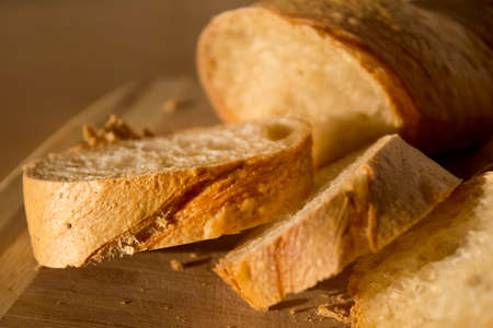 Sliced baguette on the wooden board.の写真素材