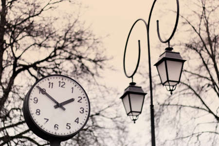Beautiful city watch with decorative lamp on the background of trees.の写真素材