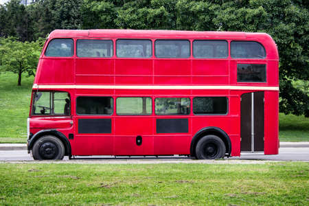 Red double decker bus parked in the city.の写真素材