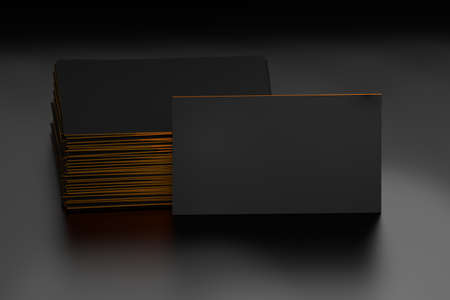 Stack of black blank business cards mockup on dark background. Cards with yellow edages. 3d illustration.の写真素材