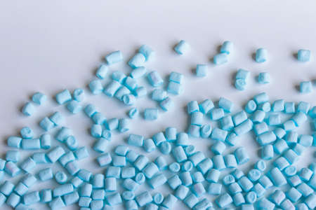 Randomly arranged small blue colored marshmallows on white backround with copy blank space.の写真素材