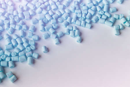 Small blue colored marshmallows on white backround with copy blank space.の写真素材