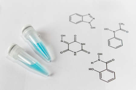 Eppendorfs with a solution of blue laccase enzyme and chemical formulas of substrates. の写真素材