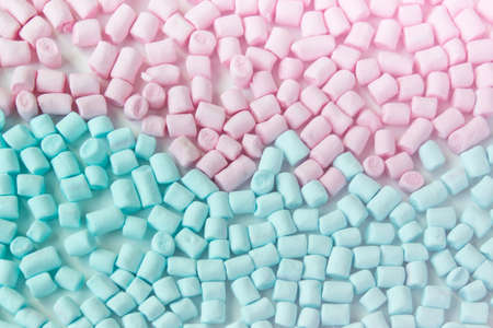 Small blue and pink colored marshmallows on white backround.の写真素材