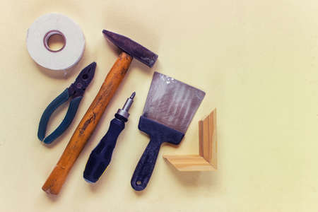 Old used household instruments, tools for home reparation on yellow background with copy space....