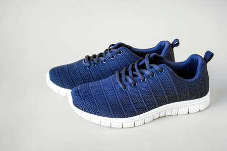 Front view of unisex blue sport shoes with lases on white background. Isolated. Photo with copy...