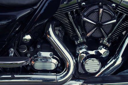 Close up of black chopper motorcycle with chrome shiny details.