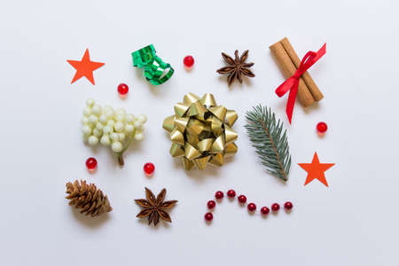 Christmas New Year greeting composition made of many small objects evergreen branch, pine cone,...