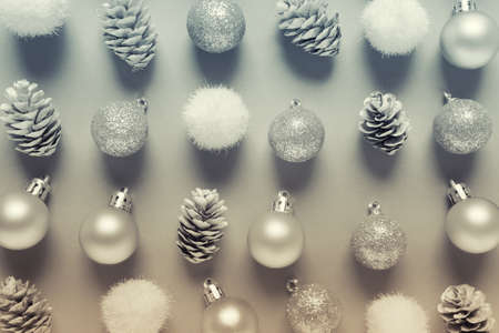 Winter Chrstimas pattern made of balls and pine cones arranged in rows in blue yellow colors.の写真素材