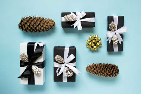 Christmas New Year arrangement of gift boxes presents with large wooden natural pine cones and...