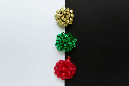 Abstract background with three Christmas colored festive bows in traditional Christmas colors red...