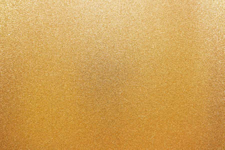 Abstract Christmas winter golden background of sparkling paper.