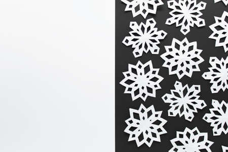 Christmas winter double colored white and black background with paper handmade snowflake pattern....