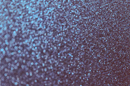 Abstract Christmas winter concept starry night background bokeh blurred sparkling paper colored in...