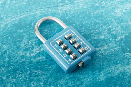 Close up of single stainless steel portable bag cabinet blue lock with code numbers buttons on blue...
