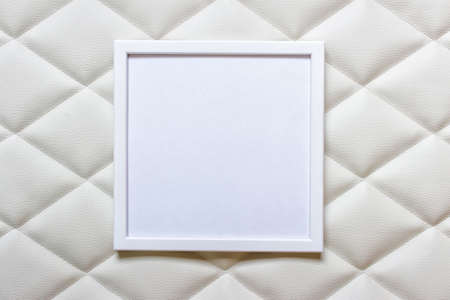 White picture frame with white blank space on white luxury tufting cloth fabric.の写真素材