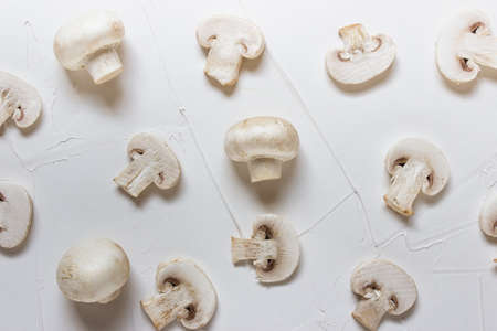 Creative background with mushroom slices on white textured background.の写真素材