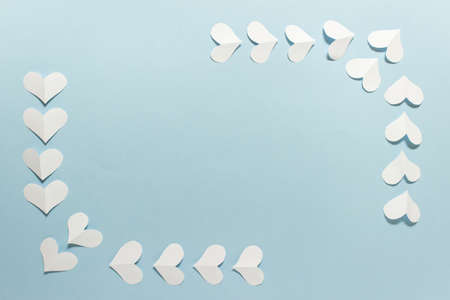 Romantic simplistic Valentine day greeting card with white folded paper hearts arranged in a frame...