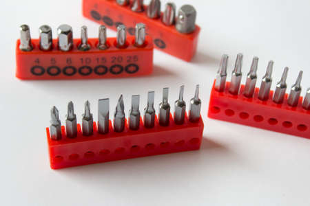 Many home electronic device repetition sets with flat and star screwdrivers on white background.