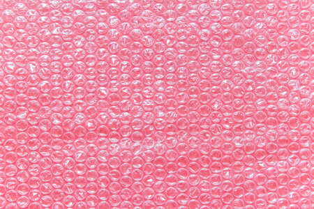 Pink air filled transparent packaging foil placed on pink backgound.