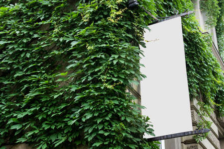 Editable stationery PSD mockup with long vertical outside shop billboardの写真素材