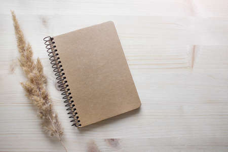 Mockup template with black blank empty notebook cover on wooden background. Photo with copy blank...