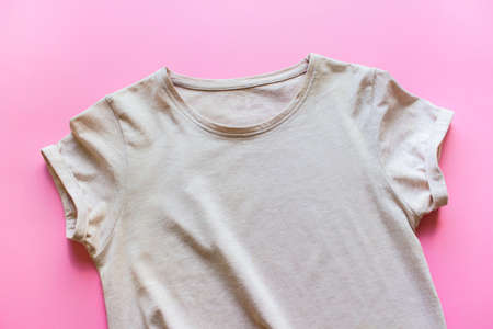 Mockup template of beige T-shirt with blank empty space on pink background.の写真素材