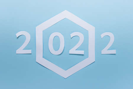 New year 2022 made of paper with large paper hexagon on blue background.の写真素材