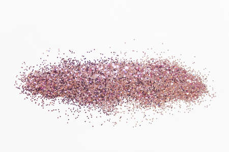 Pile of pink glitter with small round particles on white background.の写真素材